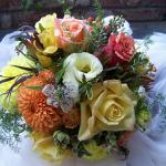 A late fall mixtue of orange and yellow Dahlias, pale yellow lLisianthus, yellow Alstormeria, Yellow mini Cymbidium Orchids, Nigella, Orange Hypericum Berries, 
Safari Sunset, Deflexux Fern, 
Featured  Roses, Yellow - Conga , Peach - Sahara - Orange Cherry Brandy